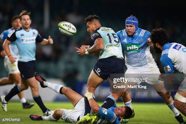 Israel Folau of the Waratahs is tackled during the round 11 Super Rugby match between the Waratahs and the Blues at Allianz Stadium on May 6, 2017 in...