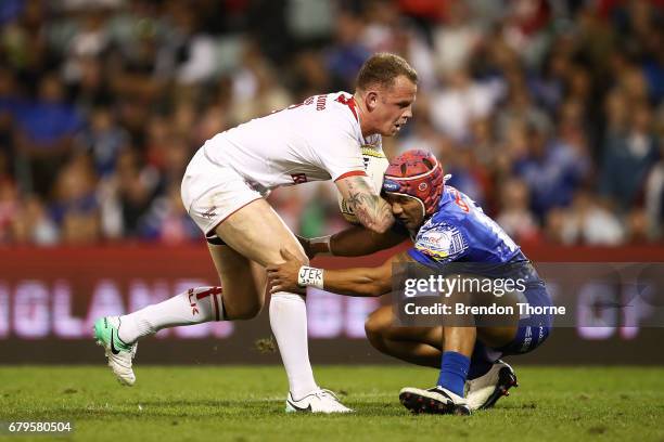 Kevin Brown of England fends off Pita Godinet of Samoa during the 2017 Pacific Test Invitational match between England and Samoa at Campbelltown...