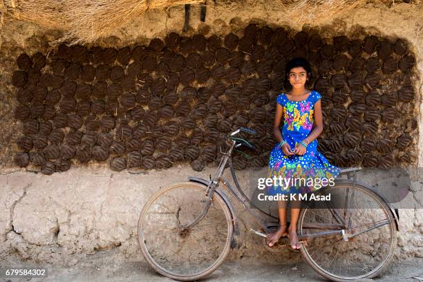 Little girl with her bicycle at west Bengal area, India. Now a days bicycle is a popular vehicle for rural people.