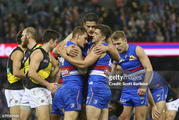 Clay Smith of the Bulldogs, Tom Boyd of the Bulldogs, Lachie Hunter of the Bulldogs and Tom Liberatore of the Bulldogs celebrate at the final siren...