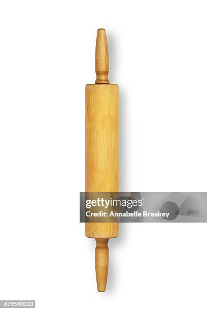 overhead of wooden rolling pin on white surface - deegrol stockfoto's en -beelden