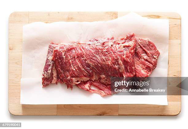 raw skirt steak on parchment paper on wood - annabelle(2014) ストックフォトと画像