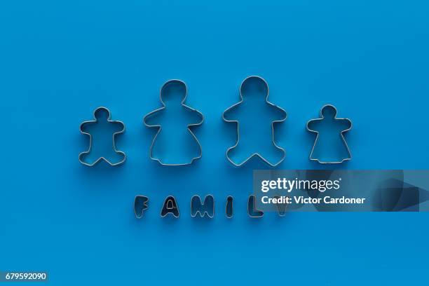 cookie shape cutters on blue background - cookie cutter stock pictures, royalty-free photos & images