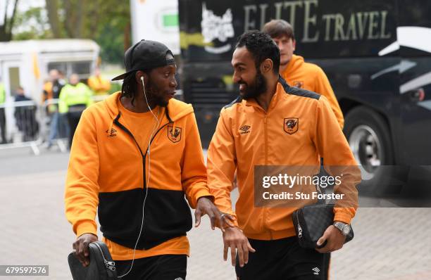 Dieumerci Mbokani of Hull City and Ahmed Elmohamady of Hull City arrive at the stadium prior to the Premier League match between Hull City and...