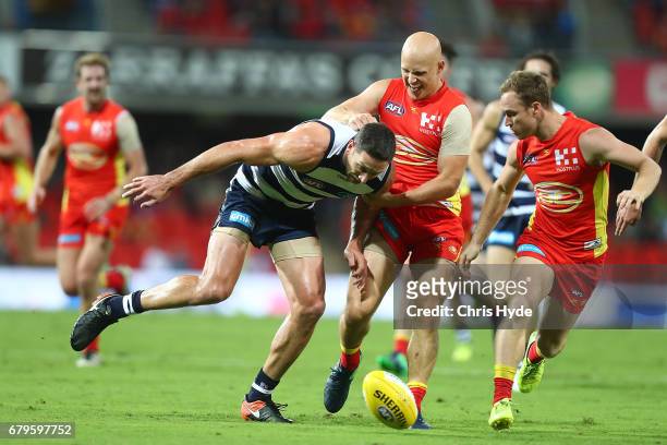 Gary Ablett of the Suns and Harry Taylor of the Cats compete for the ball during the round seven AFL match between the Gold Coast Suns and the...