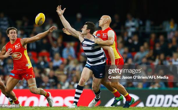 Patrick Dangerfield of the cats challenges for posession with Gary Ablett of the suns during the round seven AFL match between the Gold Coast Suns...