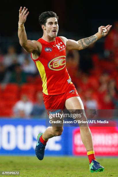 Alex Sexton of the Suns celebrates a goal during the round seven AFL match between the Gold Coast Suns and the Geelong Cats at Metricon Stadium on...