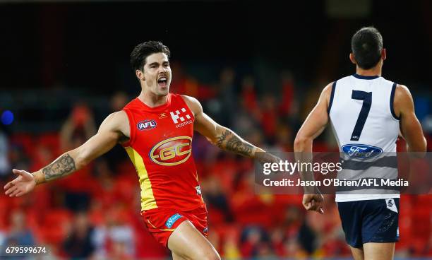 Alex Sexton of the Suns celebrates a goal during the round seven AFL match between the Gold Coast Suns and the Geelong Cats at Metricon Stadium on...