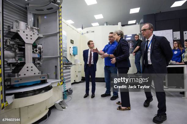 British Prime Minister Theresa May and West Midlands Mayor Andy Street are taken on a tour of the UTC Aerospace Systems factory during a campaign...