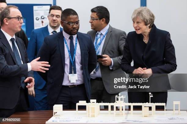 British Prime Minister Theresa May speaks with General Manager at UTC Aerospace Systems Robert Hupfer as she tours the UTC Aerospace Systems factory...