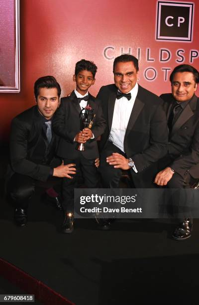 Varun Dhawan, Sunny Pawar, winner of the Rising Star of the Year award, Nick Bassi and Sanjeev Bhaskar attend The Asian Awards at Hilton Park Lane on...