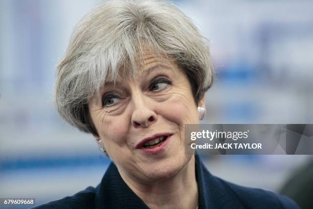 British Prime Minister Theresa May tours the UTC Aerospace Systems factory in Wolverhampton, central England on May 6 as campaigning continues in the...