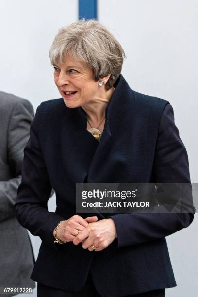 British Prime Minister Theresa May tours the UTC Aerospace Systems factory in Wolverhampton, central England on May 6 as campaigning continues in the...
