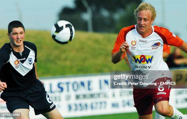 Queensland Roar striker Mitchell Nichols, right, and Victory's Cameron Drake