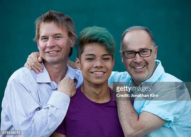 Two dads with transgender son portrait.