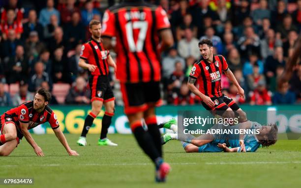 Stoke City's Welsh midfielder Joe Allen reacts after a foul by Bournemouth's English-born Irish midfielder Harry Arter during the English Premier...