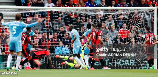 Bournemouth's French midfielder Lys Mousset watches the ball after scoring an own goal during the English Premier League football match between...