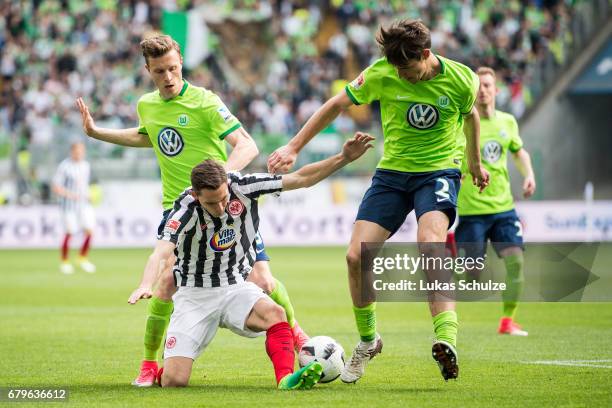 Yannick Gerhardt of Wolfsburg, Varela Guillermo of Frankfurt and Philipp Wollscheid of Wolfsburg fight for the ball during the Bundesliga match...