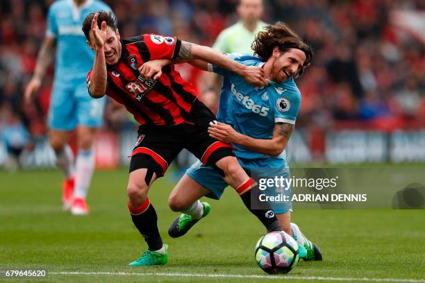 Bournemouth's English defender Adam Smith vies with Stoke City's Welsh midfielder Joe Allen during the English Premier League football match between...