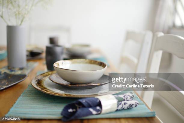 beautifully set table with handmade ceramic dishes and wooden accents - place mat stock pictures, royalty-free photos & images