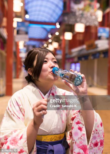 hoge-tiener meisje in hakama fles frisdrank drinken - asian female friends drinking soda outdoor stockfoto's en -beelden