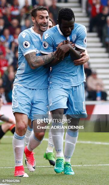 Stoke City's Senegalese striker Mame Biram Diouf celebrates scoring his team's second goal with Stoke City's US defender Geoff Cameron during the...