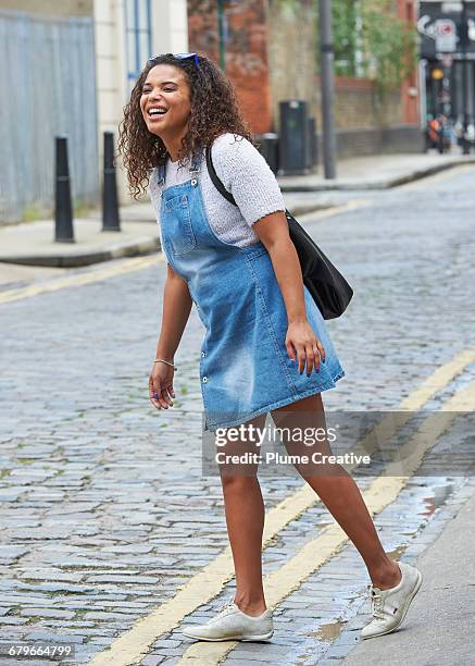 candid portrait of woman on street - pinafore kleid stock-fotos und bilder