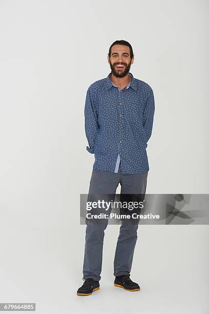 full length of portrait of man in studio - grey shirt ストックフォトと画像