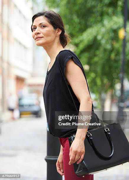 woman looking for cab - three quarter length stock pictures, royalty-free photos & images