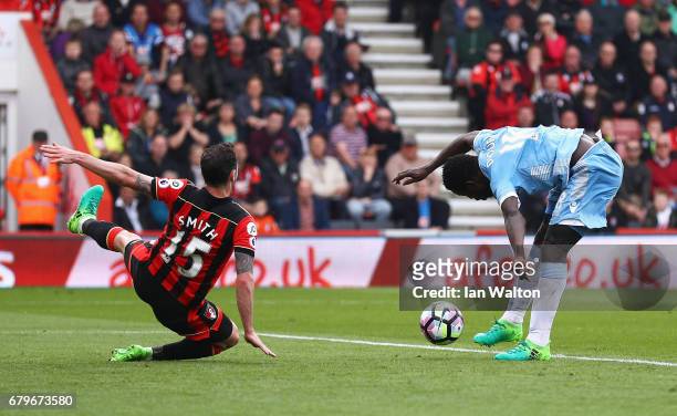 Mame Biram Diouf of Stoke City scores his sides second goal as Adam Smith of AFC Bournemouth attempts to block during the Premier League match...