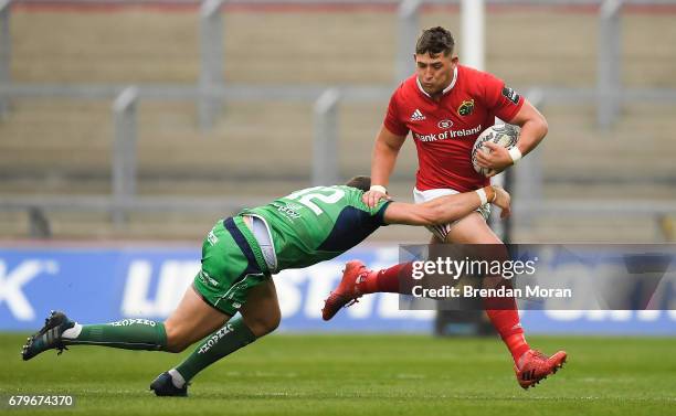 Munster , Ireland - 6 May 2017; Dan Goggin of Munster is tackled by Craig Ronaldson of Connacht during the Guinness PRO12 Round 22 match between...