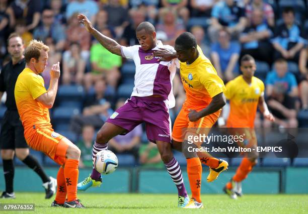 Aston Villa's Leandro Bacuna battles for possession of the ball with Wycombe Wanderers' Anthony Stewart and Stuart Lewis