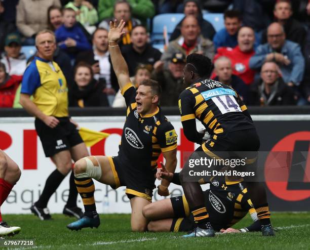 Jimmy Gopperth of Wasps celebrates as team mate Christian Wade touches down for a try during the Aviva Premiership match between Wasps and Saracens...