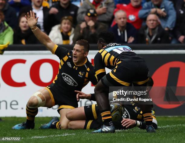 Jimmy Gopperth of Wasps celebrates as team mate Christian Wade touches down for a try during the Aviva Premiership match between Wasps and Saracens...