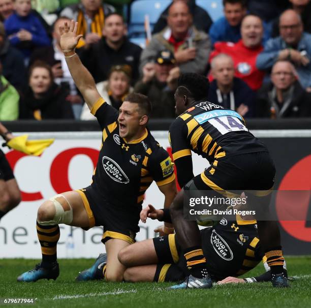 Jimmy Gopperth of Wasps celebrates as team mate Christian Wade touches down for a try during the Aviva Premiership match between Wasps and Saracens...