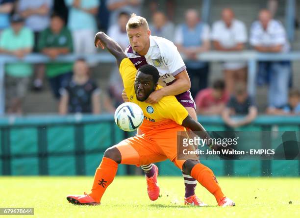 Wycombe Wanderers' Junior Morias and Aston Villa's Nathan Baker battle for possession of the ball