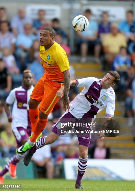 Wycombe Wanderers' Dean Morgan and Aston Villa's Josh Webb battle for possession of the ball