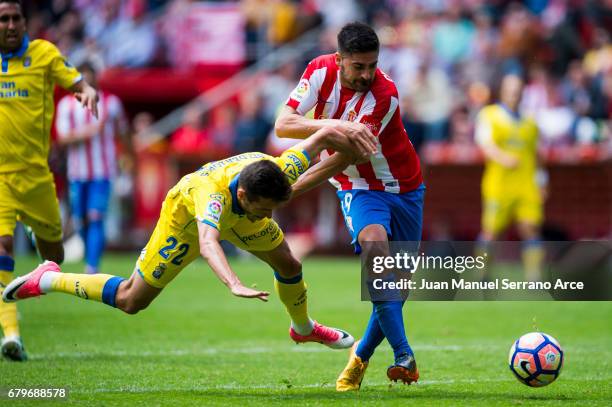 Helder Lopes of UD Las Palmas duels for the ball with Carlos Carmona of Real Sporting de Gijon during the La Liga match between Real Sporting de...