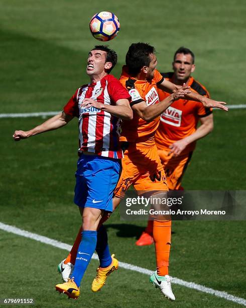 Diego Godin of Atletico de Madrid wins the header after Gonzalo Escalante of SD Eibar during the La Liga match between Club Atletico de Madrid and SD...