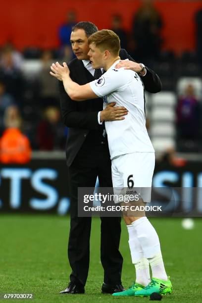 Swansea City's English head coach Paul Clement celebrates with Swansea City's English defender Alfie Mawson on the pitch after the English Premier...