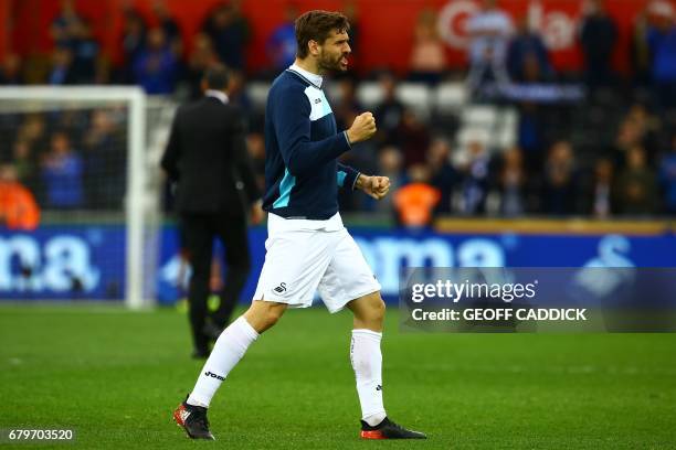 Goalscorer, Swansea City's Spanish striker Fernando Llorente celebrates on the pitch after the English Premier League football match between Swansea...