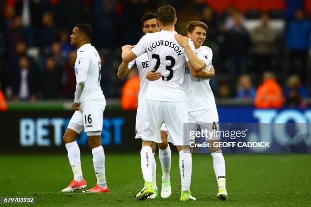 Swansea players celebrate on the pitch after the English Premier League football match between Swansea City and Everton at The Liberty Stadium in...