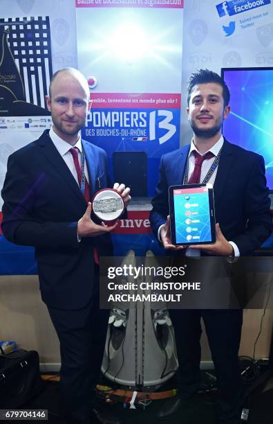 Winner of the "Concours Lepine International Paris 2017" Alexandre Defromont from Eydi technology poses with a signalisation and location beacon at...