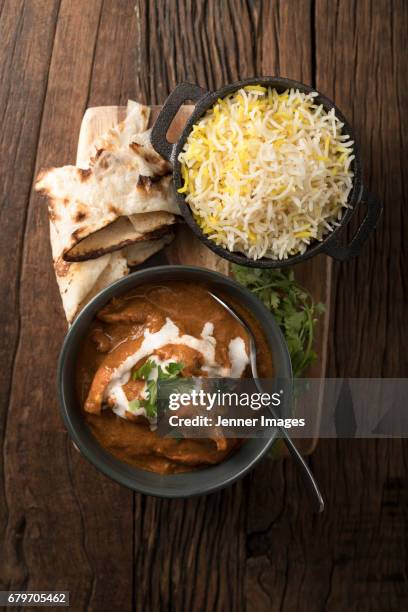 above view of indian chicken curry meal. - indian food on table stock pictures, royalty-free photos & images