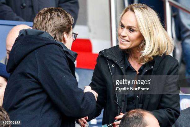 Son of former French President Jean Sarkozy and French presenter Cecile de Menibus speak together as they attend the French L1 football match between...