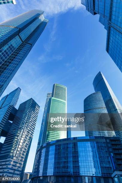 business buildings under clear blue sky - moscow international business center stock pictures, royalty-free photos & images