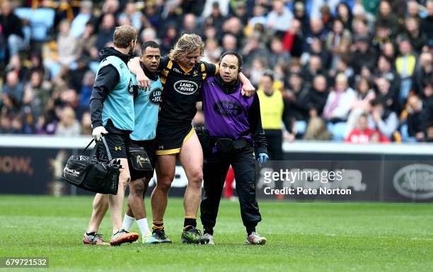 Tommy Taylor of Wasps is helped from the pitch by medical staff during the Aviva Premiership match between Wasps and Saracens at The Ricoh Arena on...