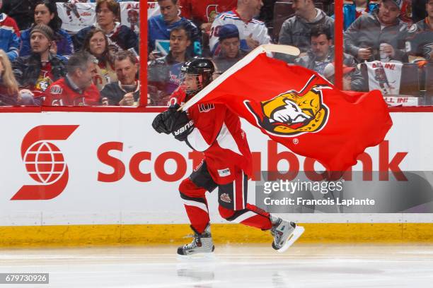 Scotiabank skater takes to the ice carrying a flag during player introductions prior to Game Five of the Eastern Conference Second Round opposing the...