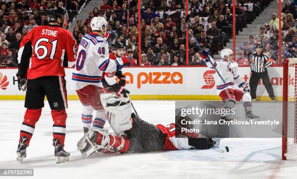 Jesper Fast of the New York Rangers celebrates his first period goal as Craig Anderson of the Ottawa Senators lies on the ice and Mark Stone of the...