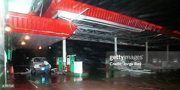 Man attemps to seek shelter from the strong winds of the Hurricane Michelle November 4, 2001 in Jaguey, Cuba.